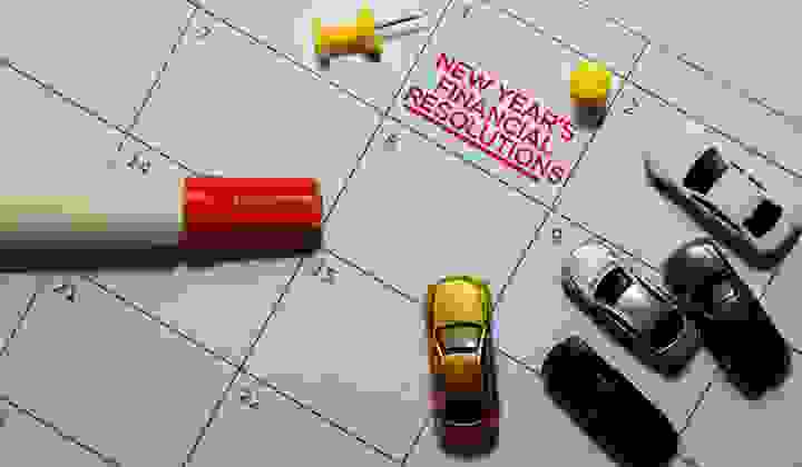 New Years Financial Resolutions on calendar with a marker and model cars
