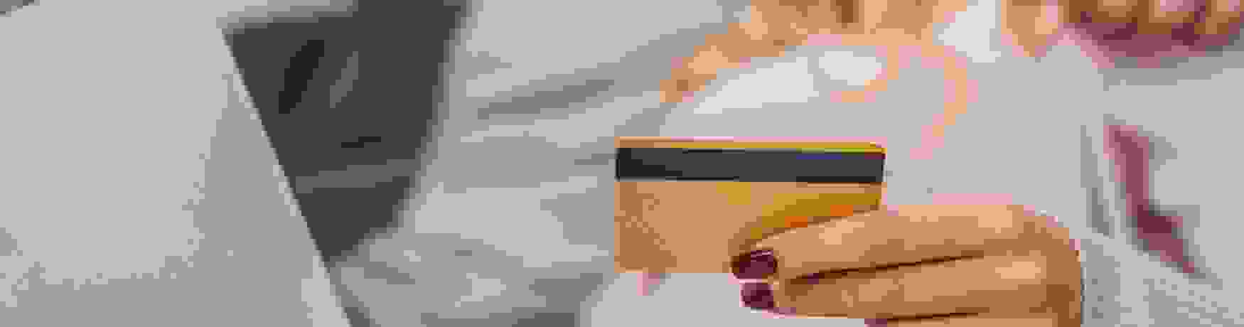 A soft focus image of a couple looking at a laptop holding a credit card in the foreground