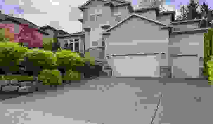 Outside view of large 3-storey house in a suburban setting from the street