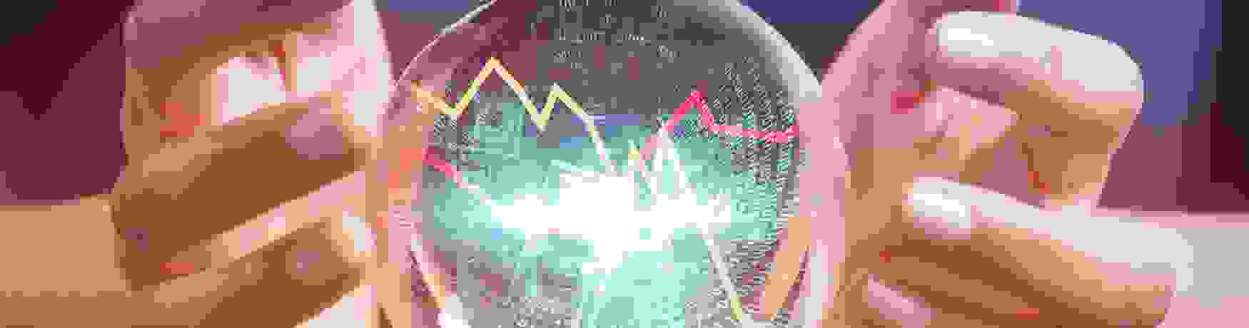 Businesswoman forecasting financial information with a crystal ball