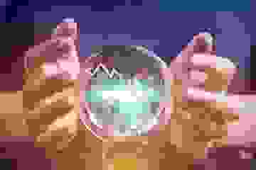 Businesswoman forecasting financial information with a crystal ball