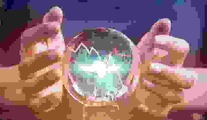 Businesswoman forecasting financial information with a crystal ball