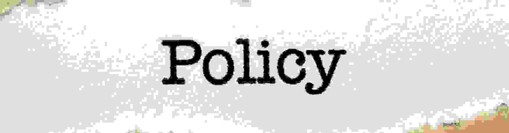 Policy statement on white card with torn Kraft paper border