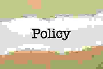 Policy statement on white card with torn Kraft paper border