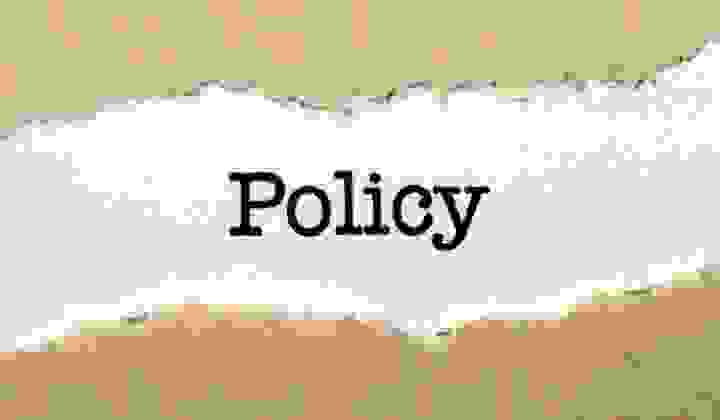 Policy statement on white card with torn Kraft paper border