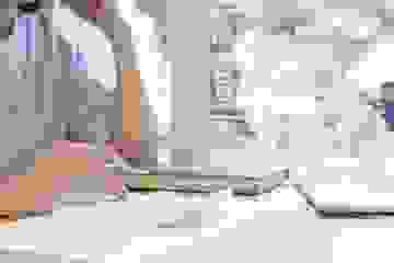 Woman at a desk with a calculator and laptop