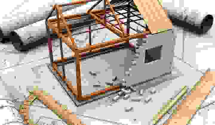 Architectural concept of building a house with plans and house model and rulers