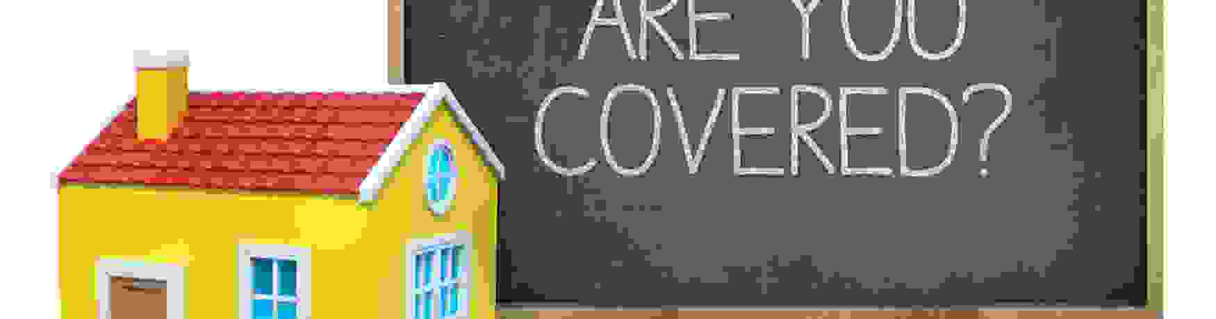 House model in front of a blackboard that says Are You Covered?