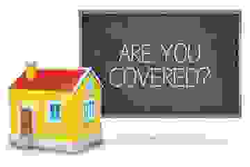 House model in front of a blackboard that says Are You Covered?
