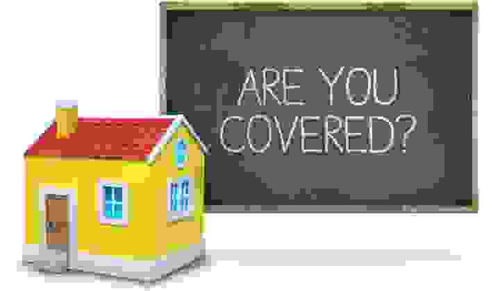 House model in front of a blackboard that says Are You Covered?