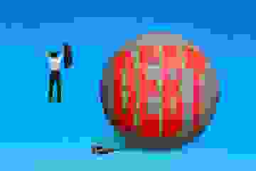 Freedom from debt concept Business man walking away from the Debt ball and chain