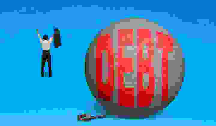 Freedom from debt concept Business man walking away from the Debt ball and chain